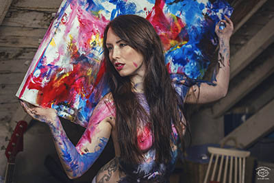 peinture sur corps d'une femme avec une toile colorée